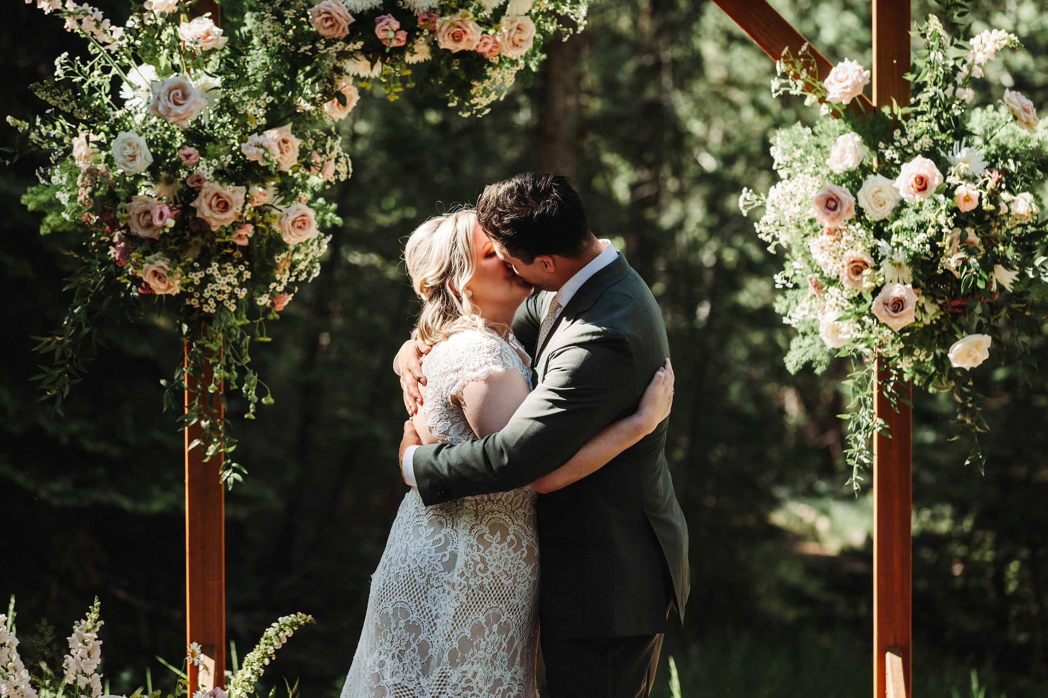 Emily & Adrian's first kiss at their intimate Colorado micro wedding in Evergreen at Juniper Lodge & Treehouses.