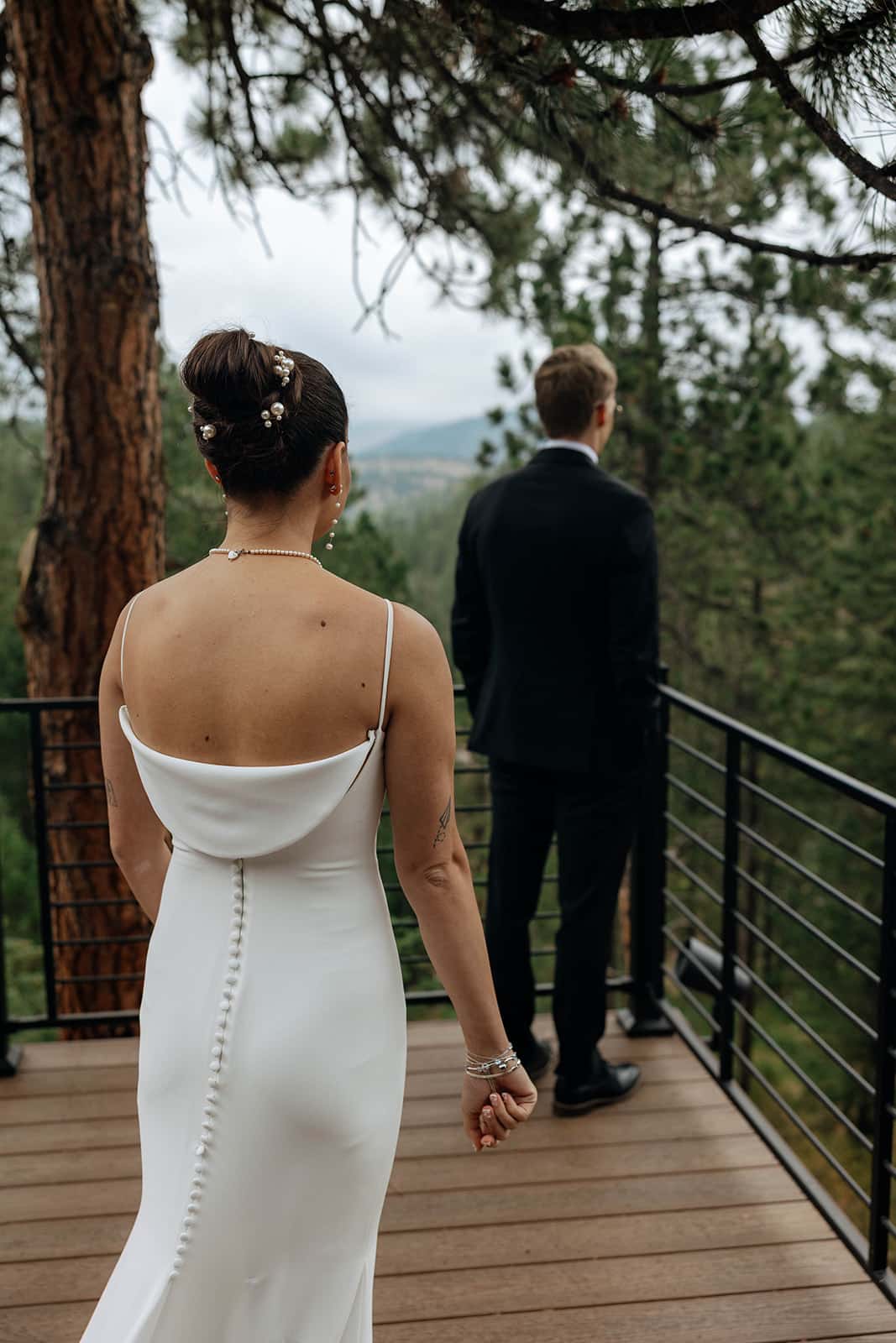 Bride and groom first look at their Evergreen mountain wedding at Juniper Lodge & Treehouses.