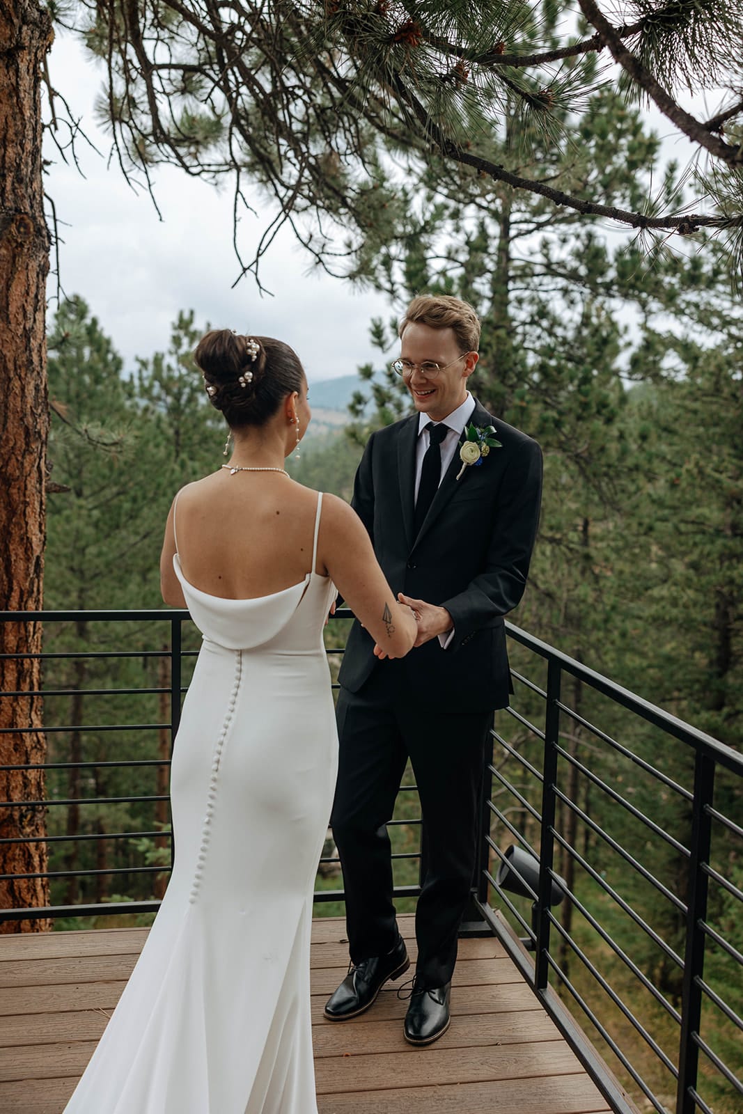 Bride and groom first look at their Evergreen mountain wedding at Juniper Lodge & Treehouses.