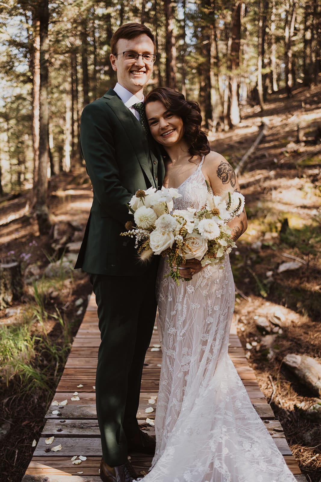 Bride and groom first look on forest bridge during Evergreen wedding at Juniper Lodge & Treehouses.