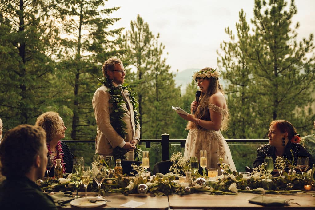 Couple sharing vows on the mountain view deck at Juniper Lodge & Treehouses in Evergreen, Colorado.