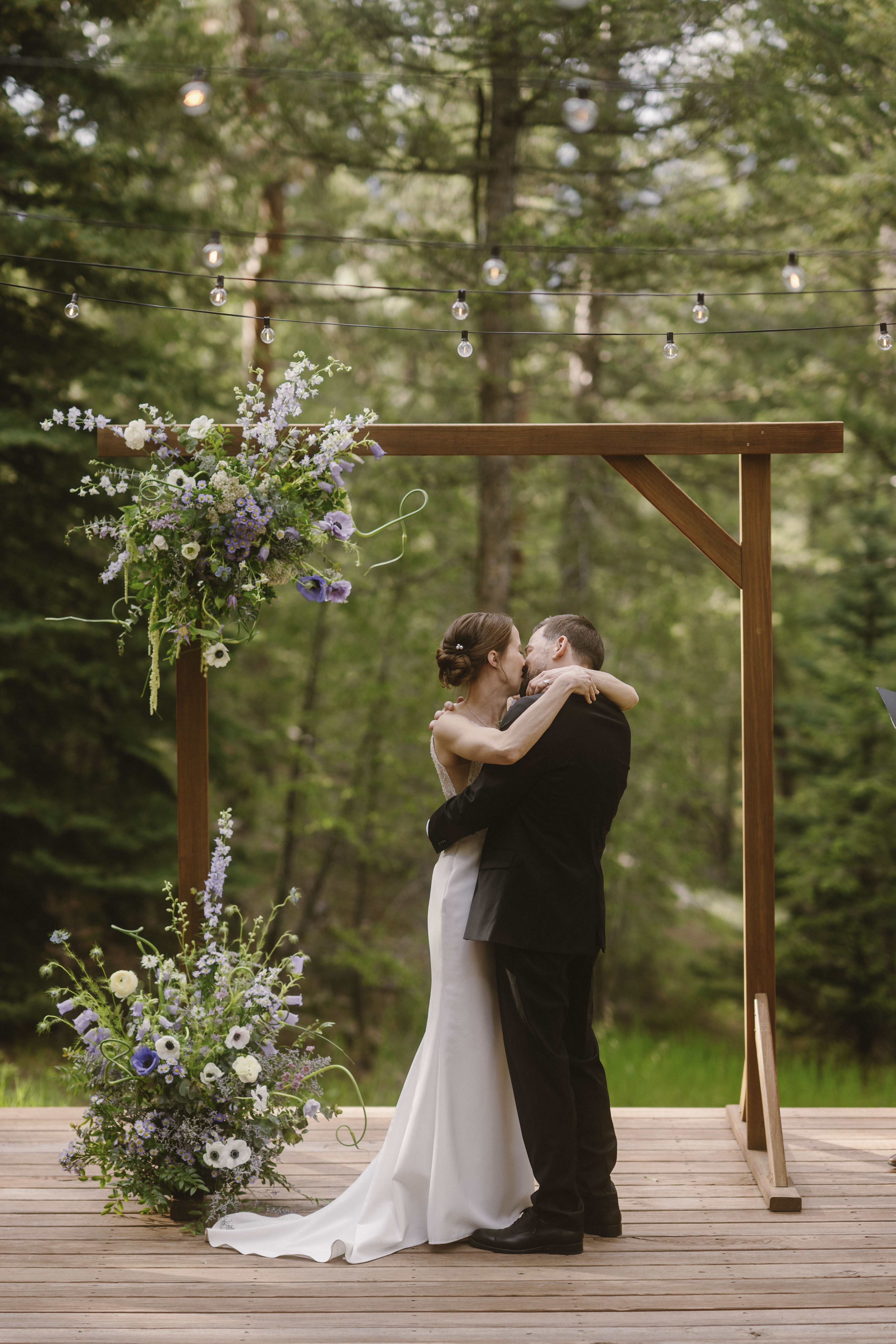 Eva & Dan's first kiss as a married couple following their spring Colorado mountain wedding ceremony at Juniper Lodge & Treehouses.