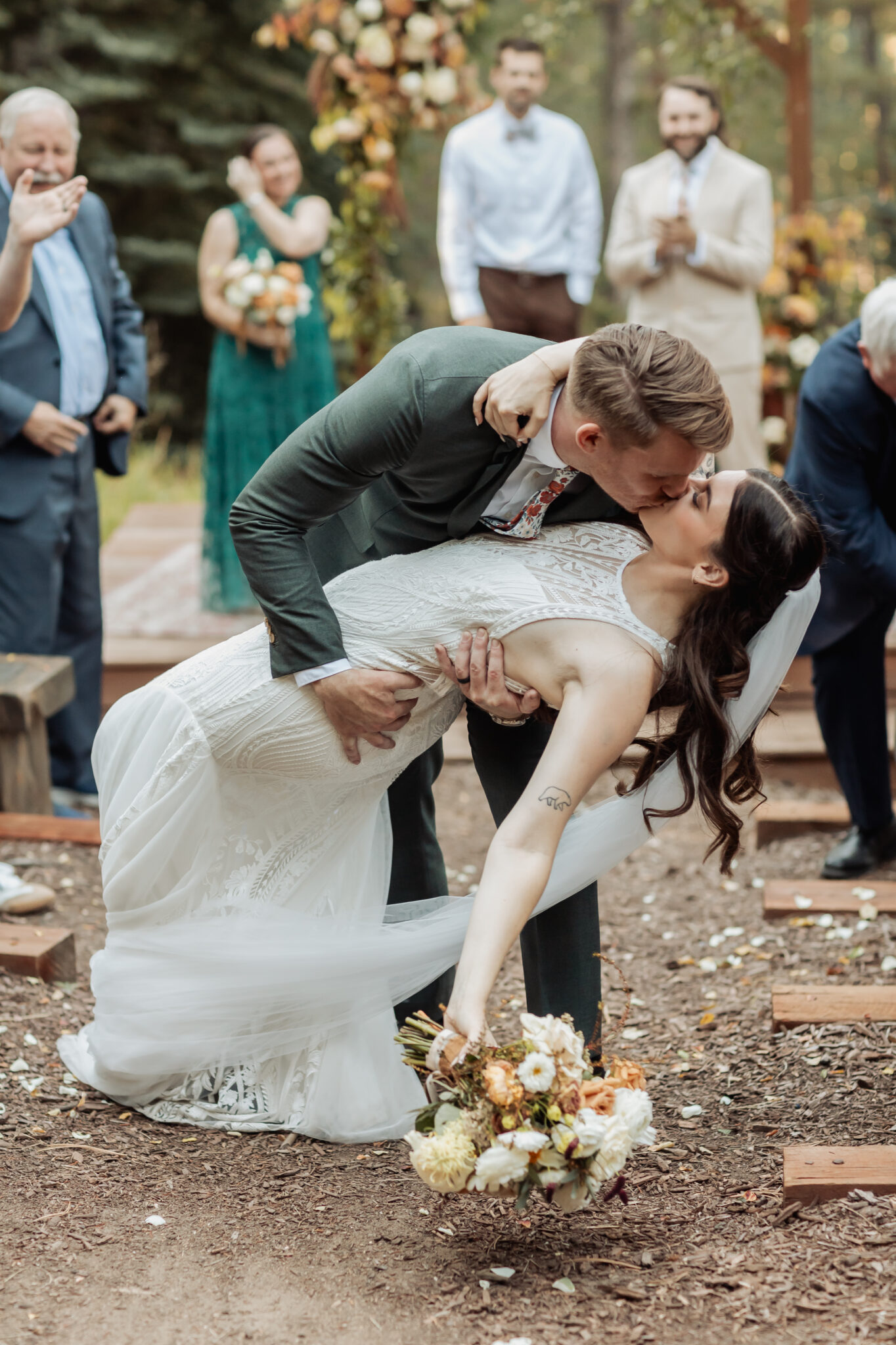 Bride and groom walking through the meadow at Juniper Lodge & Treehouses during their Evergreen Colorado wedding
