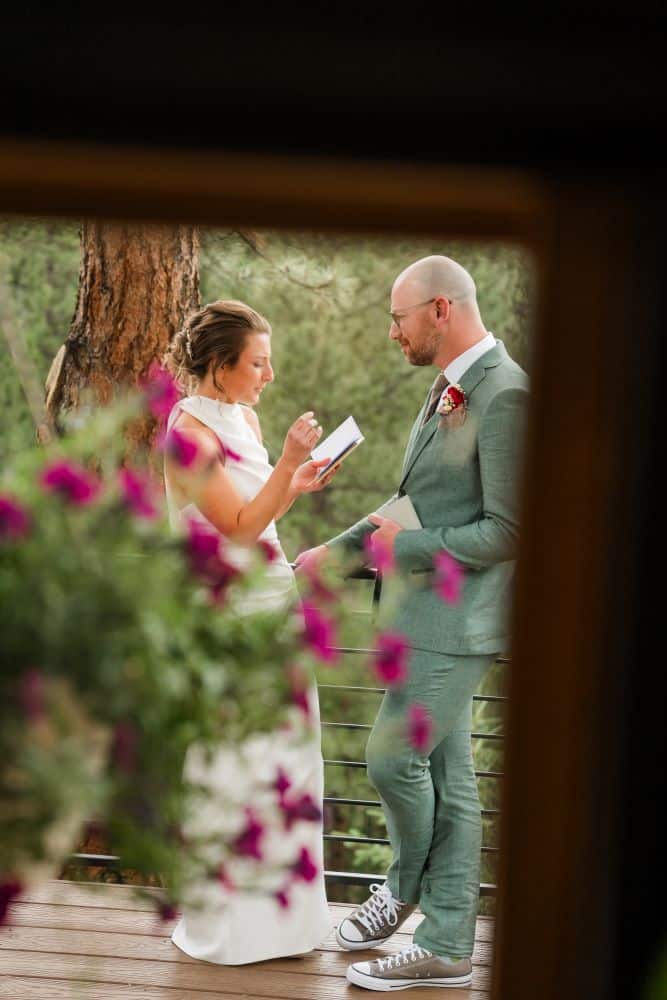 Bride and groom sharing a private first look surrounded by pine trees at Juniper Lodge & Treehouses.