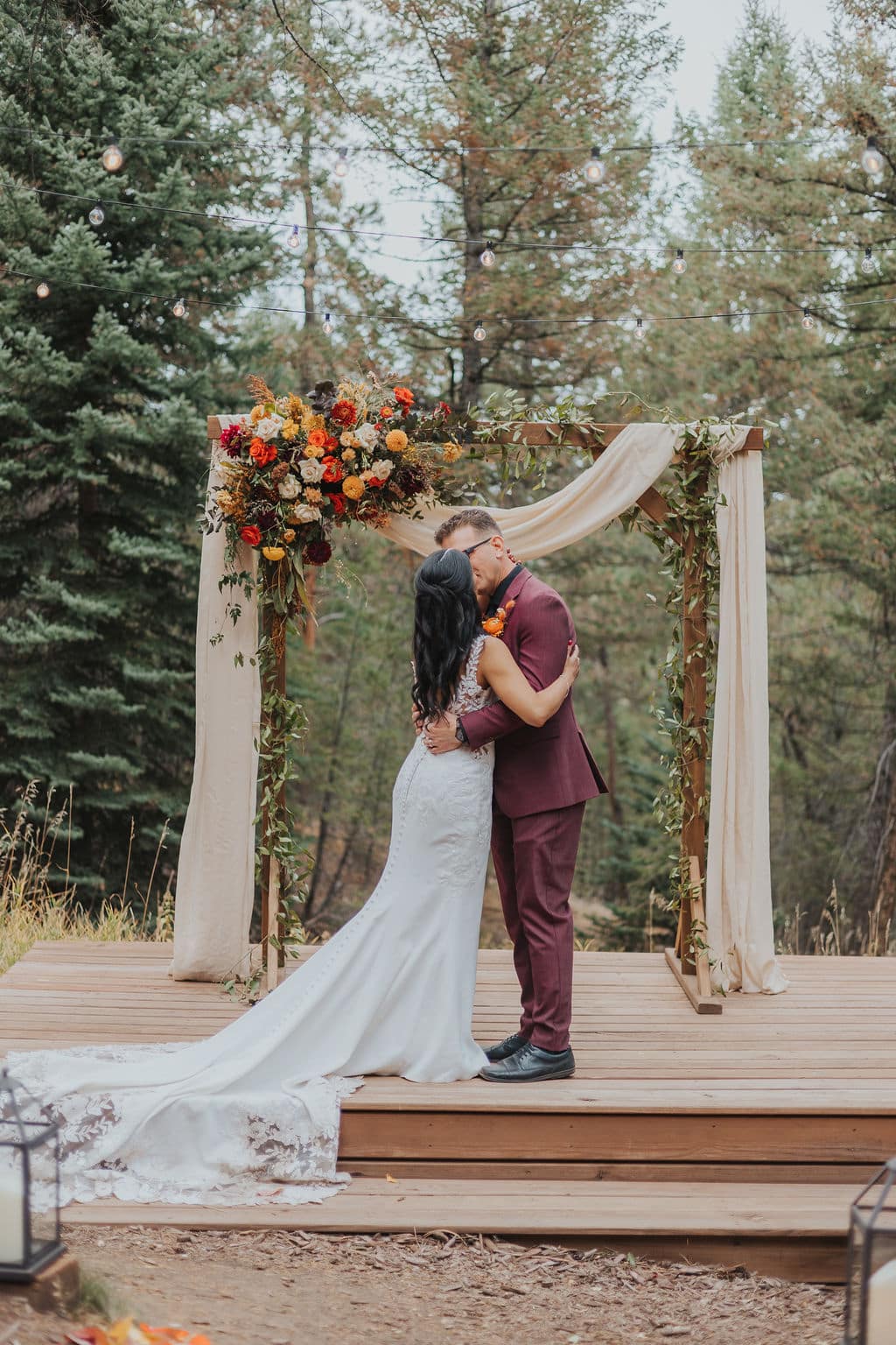 Evergreen autumn wedding ceremony at Juniper Lodge & Treehouses with orange and yellow florals.