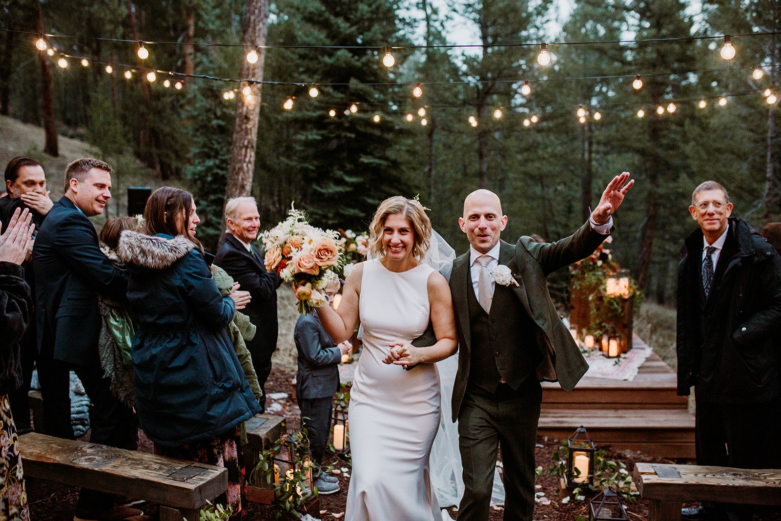 Theresa & Ryan walk down the aisle in the Meadow at Juniper Lodge & Treehouses in Evergreen, Colorado.