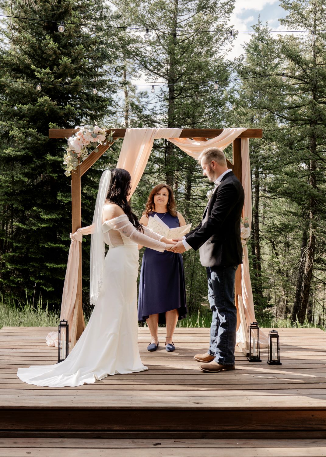 Sam and Cody exchange vows during their Evergreen Colorado wedding ceremony in the meadow at Juniper Lodge & Treehouses.