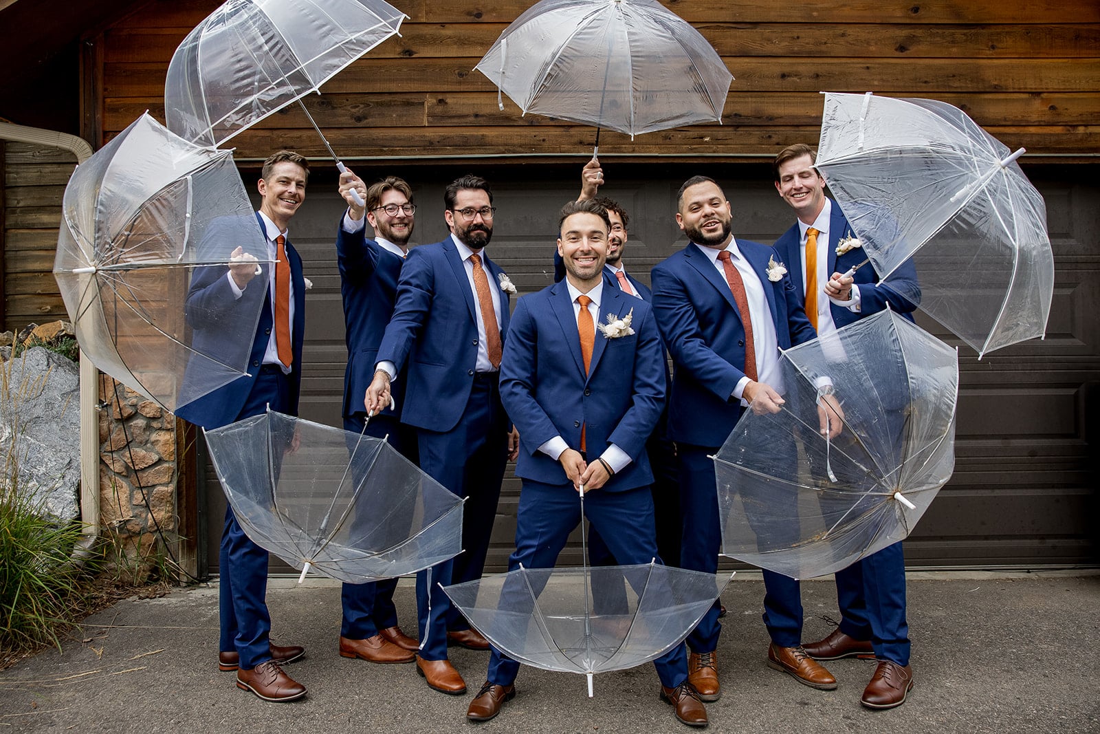 Wedding party in terracotta dresses and blue suits with orange ties