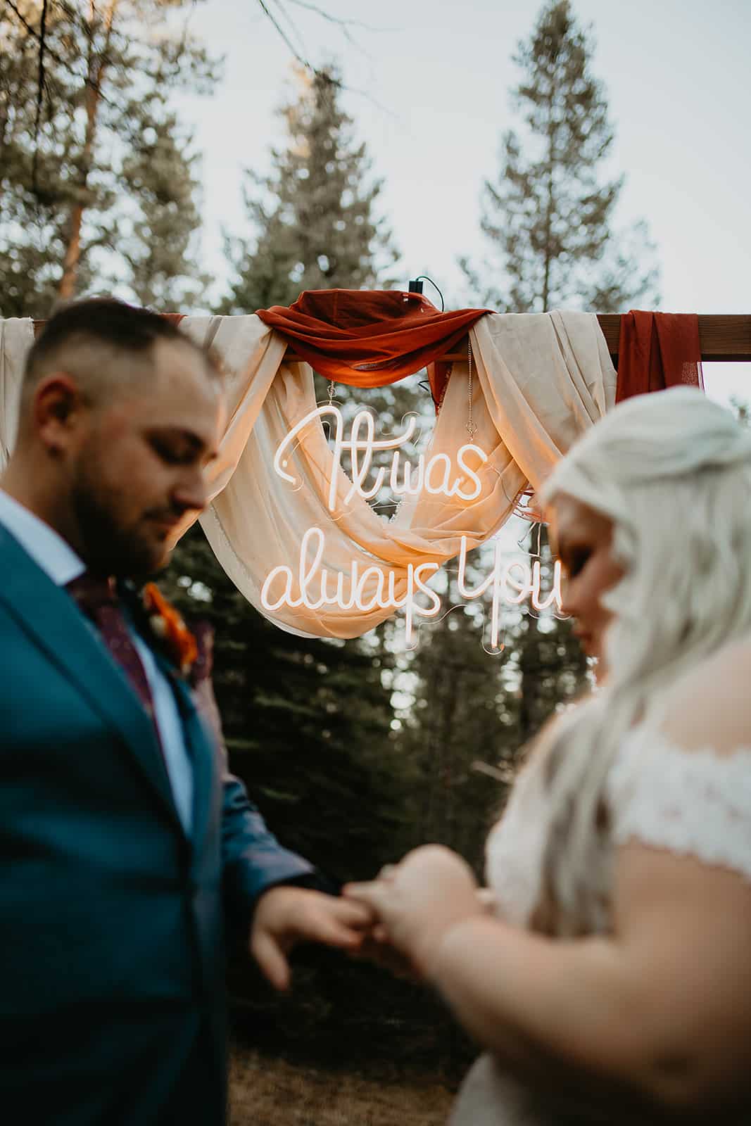 Neon sign reading ‘It Was Always You’ at Juniper Lodge & Treehouses meadow ceremony