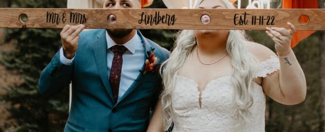 Couple taking a ski shot on the wedding platform at Juniper