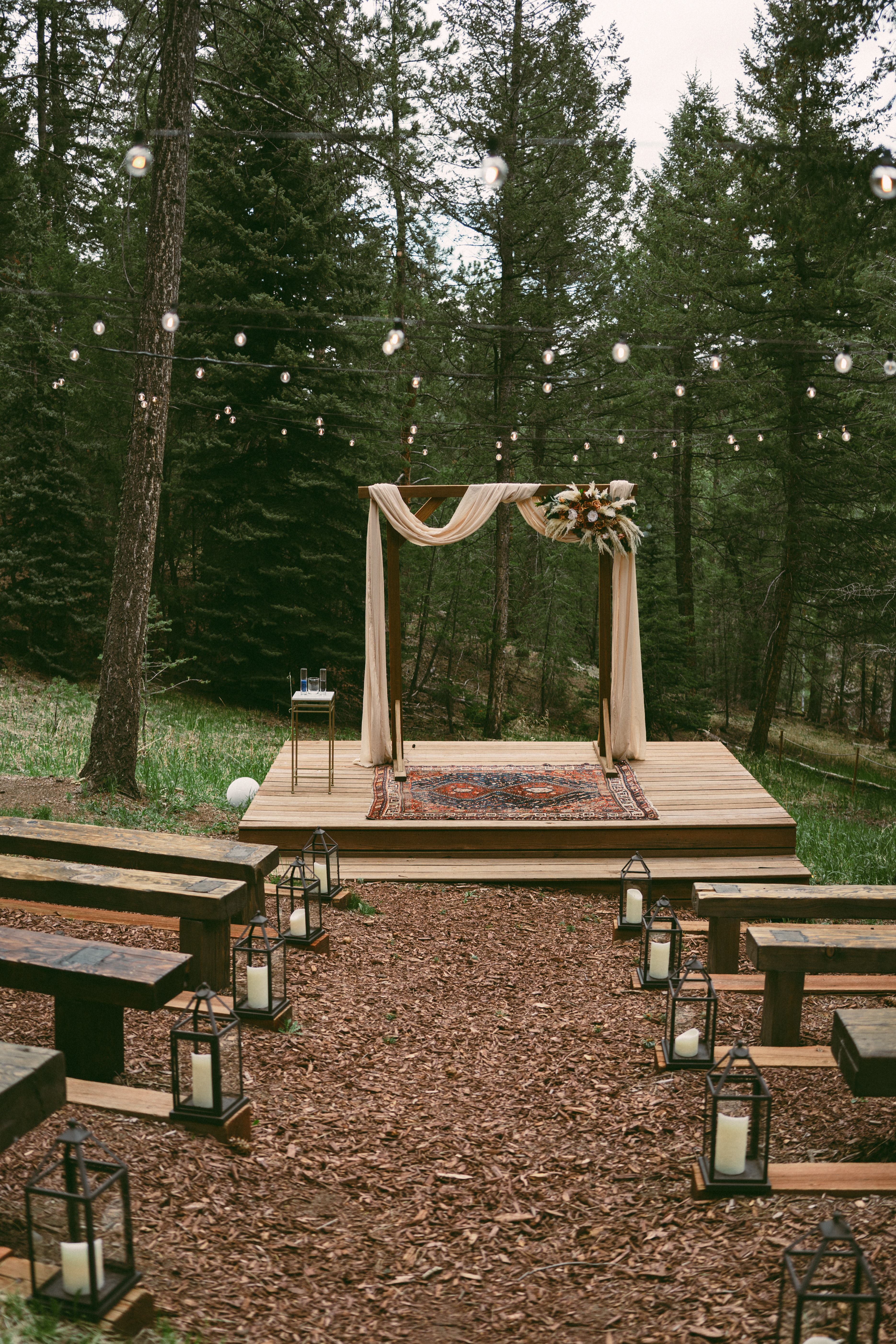 lantern-lined aisle at intimate meadow wedding at Juniper