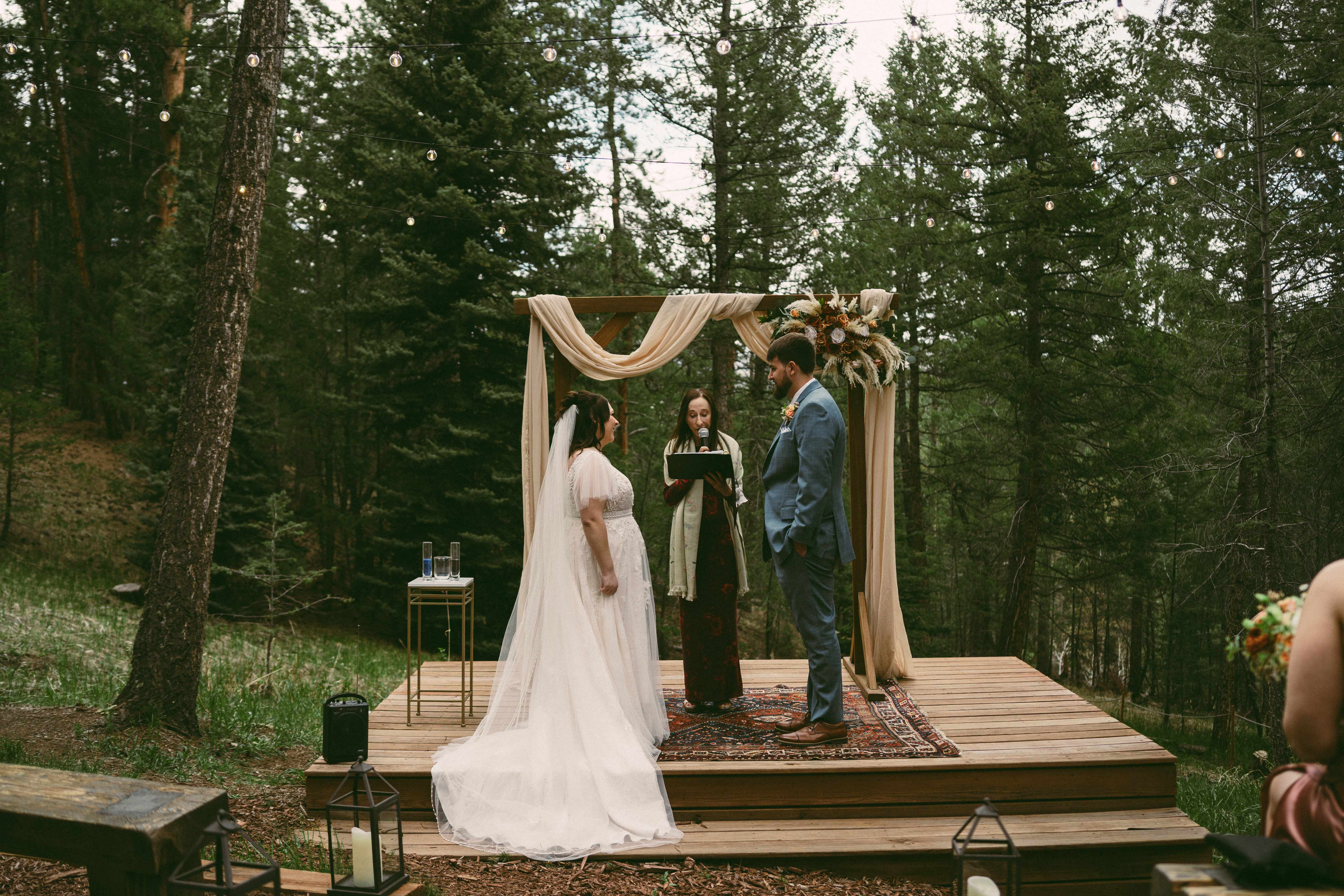 couple exchanging vows during intimate meadow wedding at Juniper