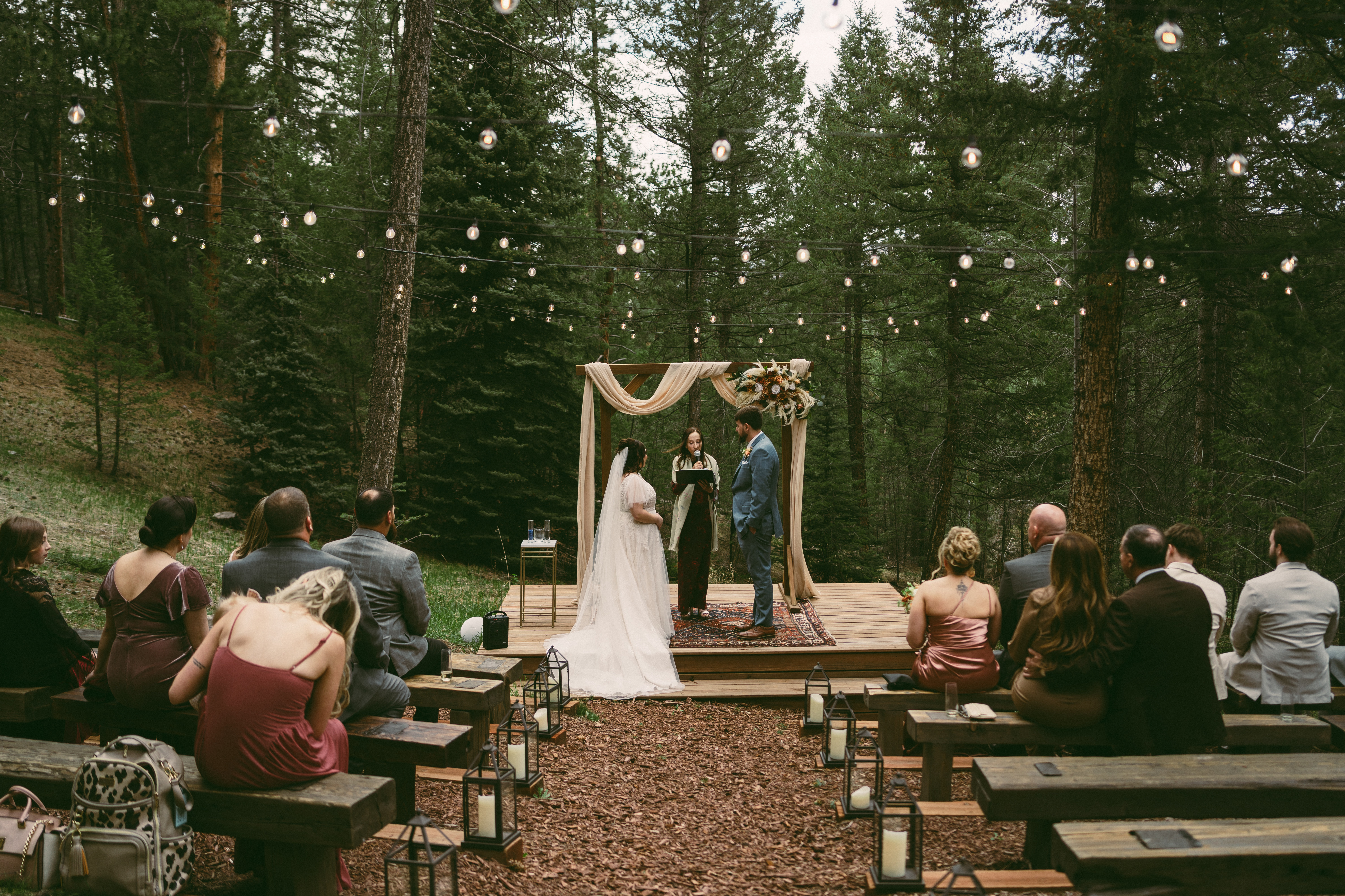 lantern-lined aisle at intimate meadow wedding at Juniper